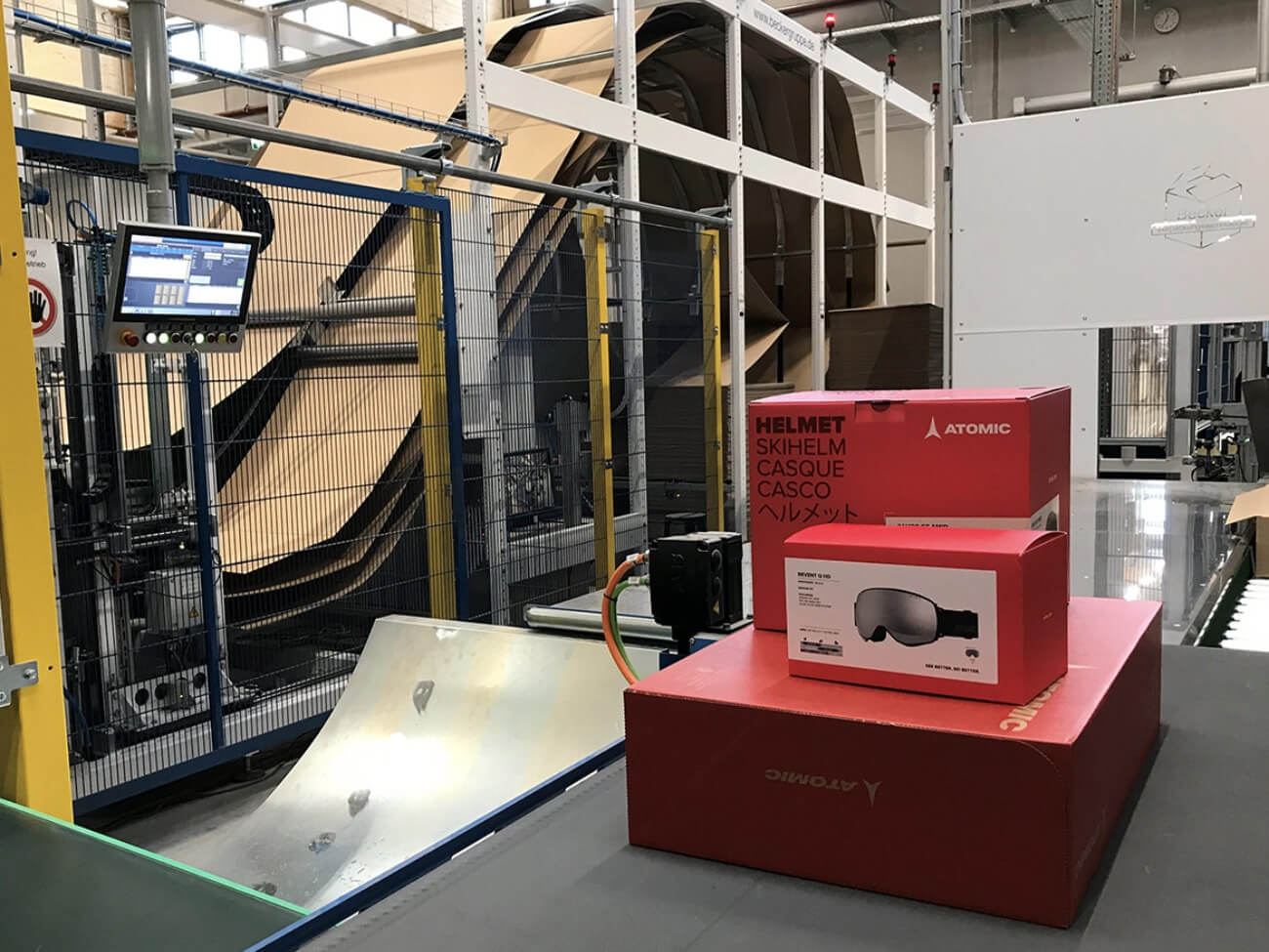 A photo of a multi-item, Atomic eCommerce order on a conveyor system before packaging with a Packsize solution.